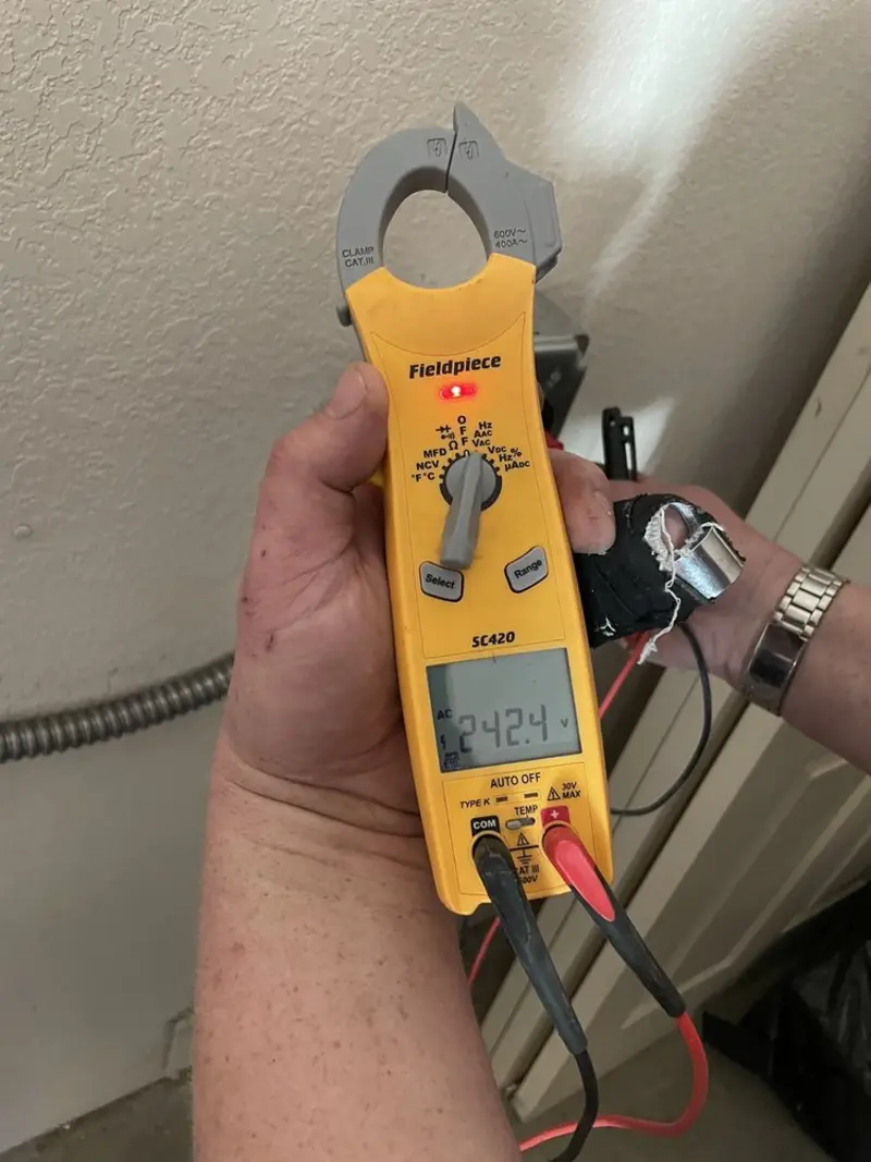 Voltage testing with clamp meter during Whole House Surge Protector in Bern